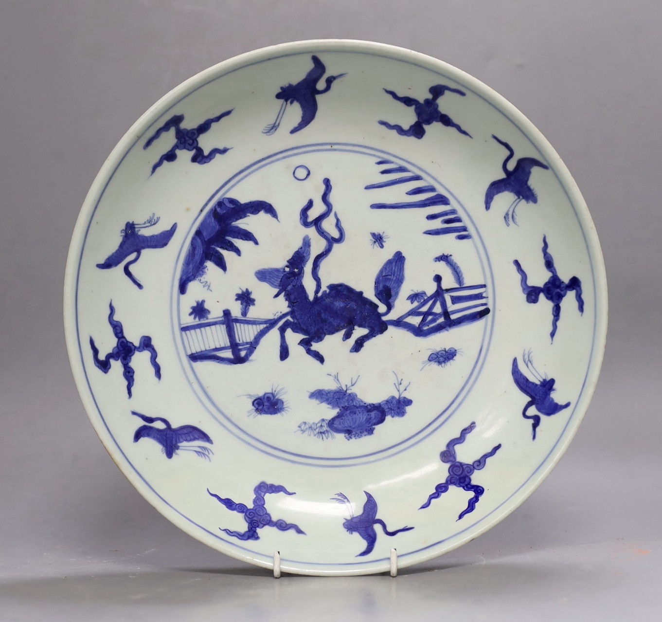 A Chinese late Ming blue and white ‘qilin, crane and rabbit’ dish, Xuande mark, Wanli period, 31cms high